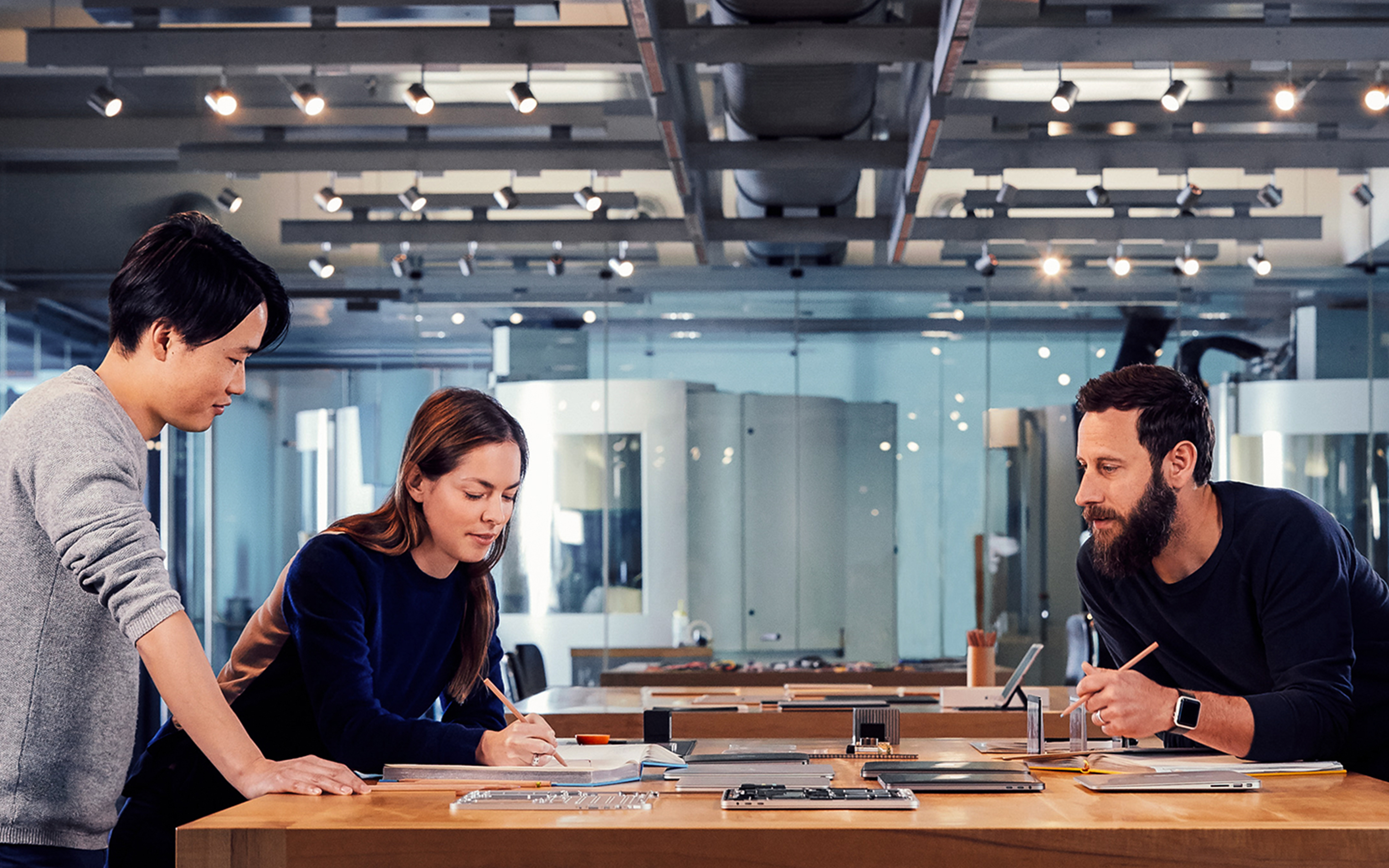 Apple designers collaborating on a project in their studio.