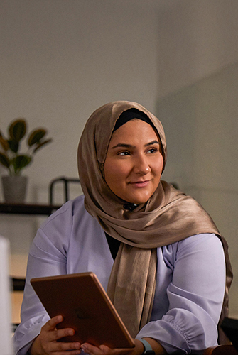 An Apple Machine Learning and AI team member holding an iPad.