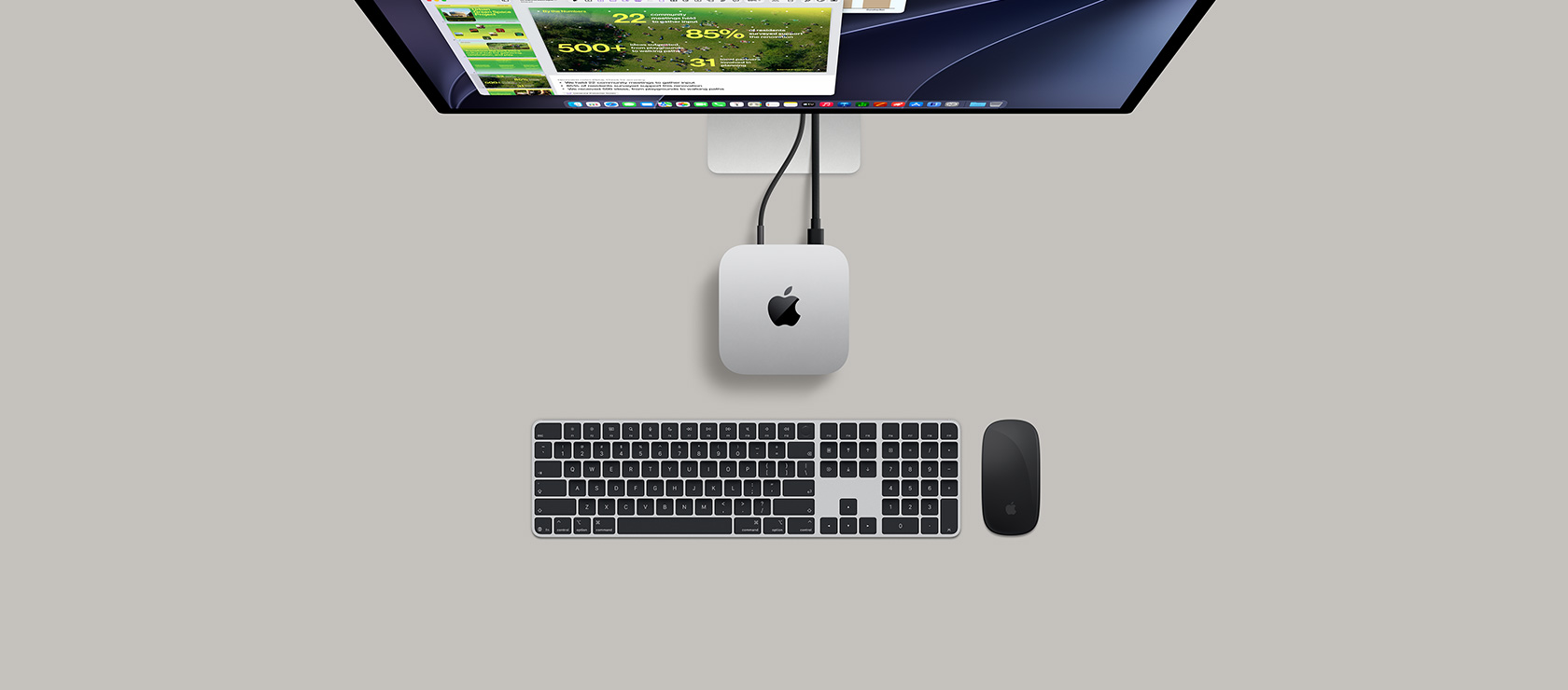 Mac mini, top, silver aluminum, rounded corners, glossy black Apple logo centered, connected by cord, Studio Display partially visible on top, AirPods 4, open, Pantone color swatches, and red Logitech keyboard and mouse
