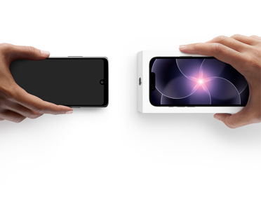 Two hands side by side, hand holding Android without box, trade-in, with hand holding new iPhone 17e box
